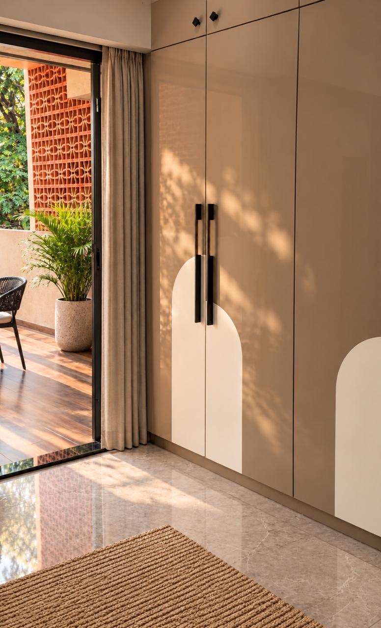 Minimalist beige wardrobe with sleek black handles